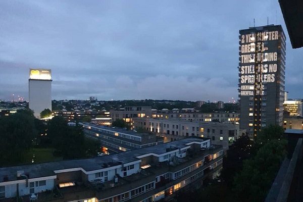 Grenfell survivors group beams safety messages onto high rises as anniversary approaches