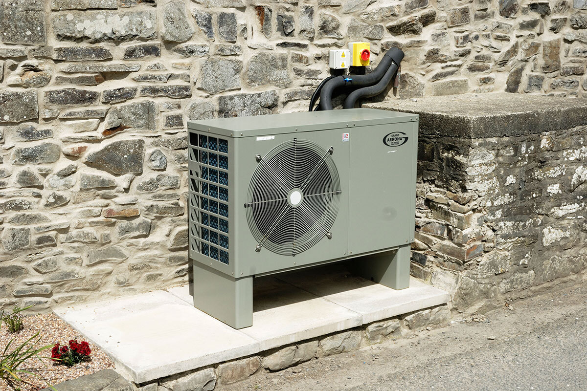 A heat pump fitted on a stone wall