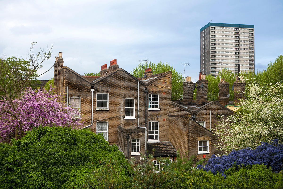 Terraced houses with an old tower block of flats behind them