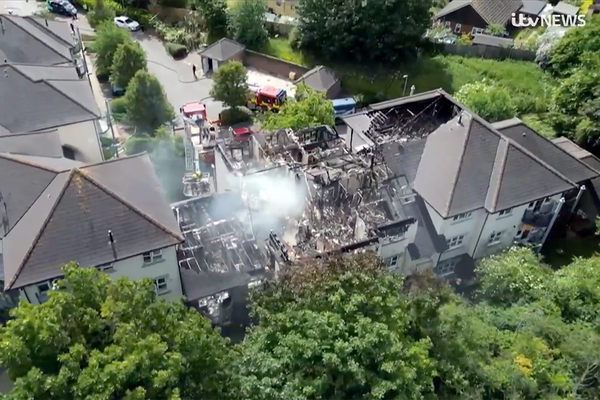 Redacted incident report indicates fire spread through gaps or voids in construction at low-rise SNG block