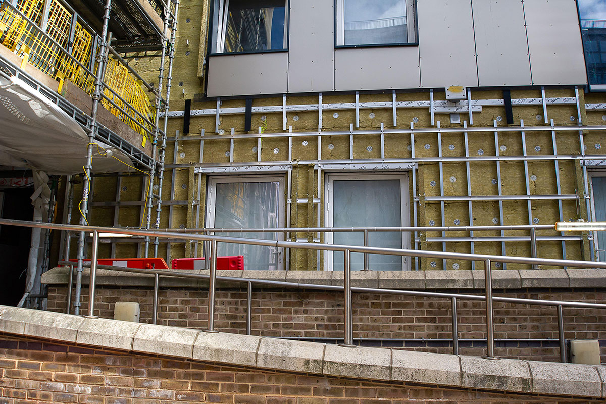 Cladding being removed from a block Cladding being removed from a block