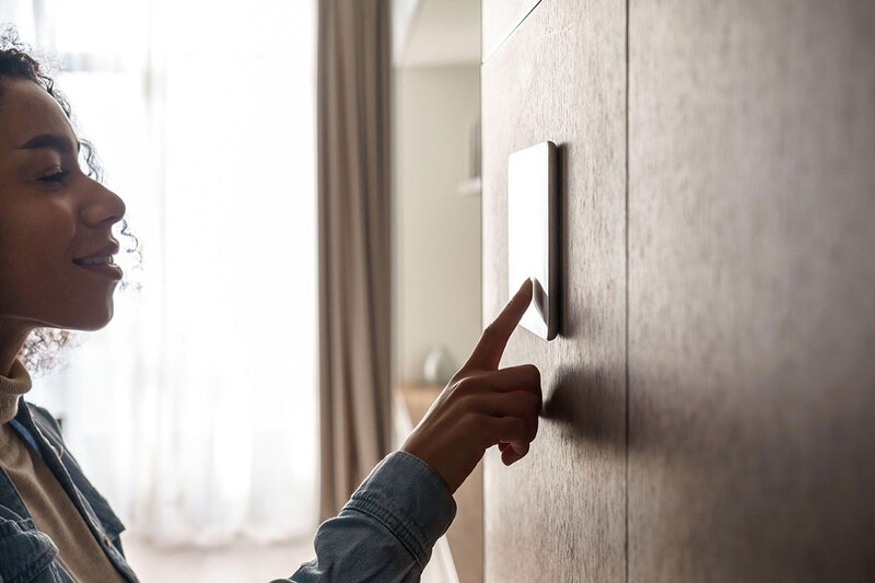 A woman using smart home tech A woman using smart home tech