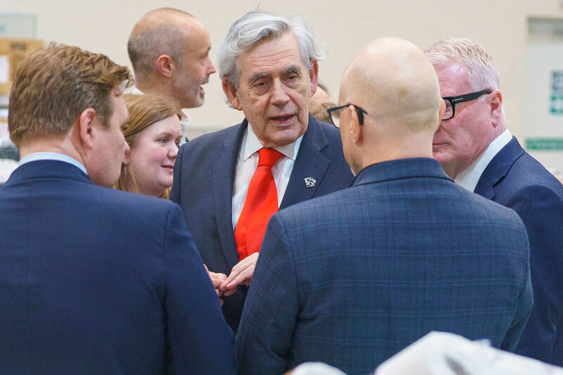 Gordon Brown speaking to several men in suits Gordon Brown speaking to several men in suits