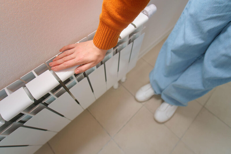 A person next to a radiator
