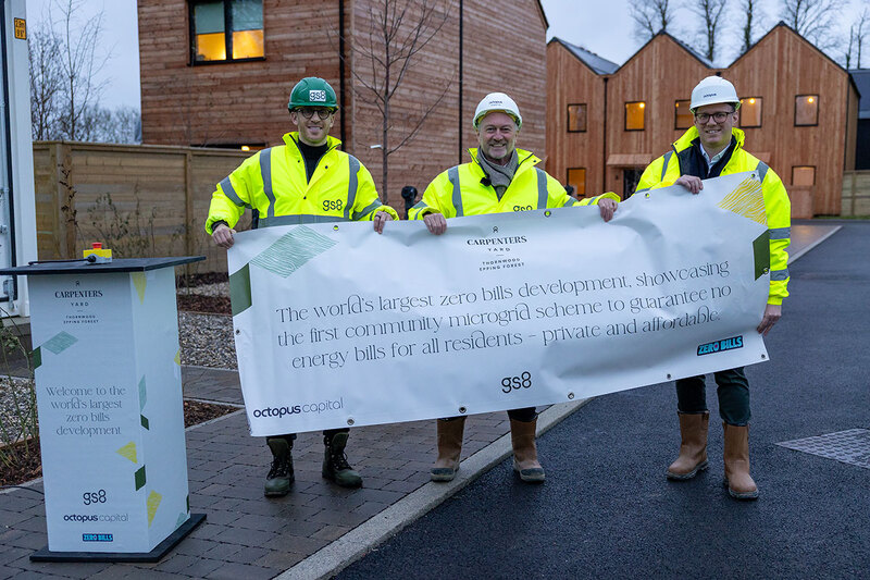 Three men holding a banner at a housing development in Essex Three men holding a banner at a housing development in Essex