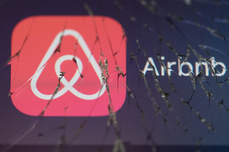 Airbnb&rsquo;s logo on cracked screen