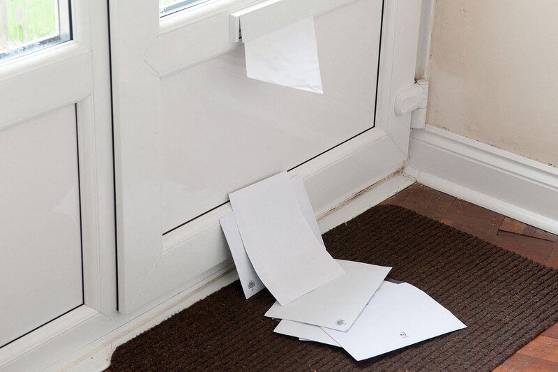 Letters piling up through a front door Letters piling up through a front door