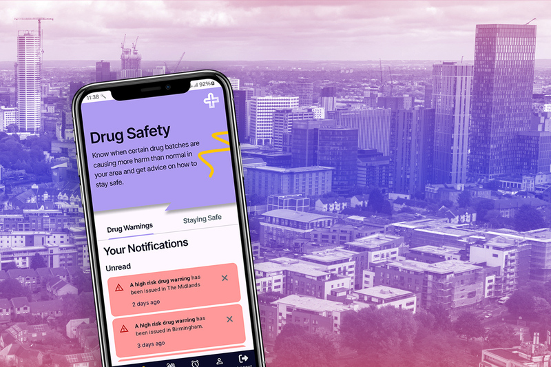 A phone displaying the Scienap app home screen superimposed on an urban skyline A phone displaying the Scienap app home screen superimposed on an urban skyline