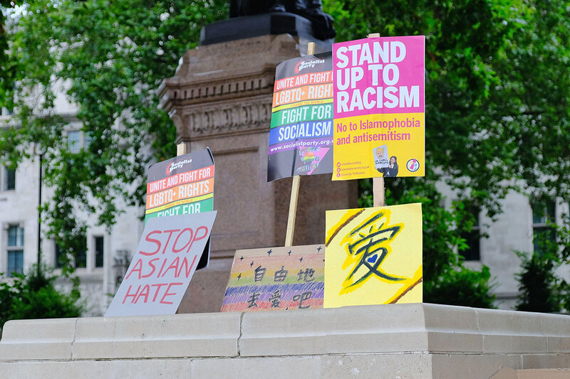 Placards protesting racist and homophobic hate crimes