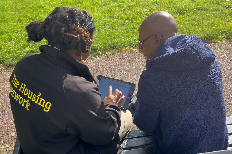 A housing officer speaking to a customer