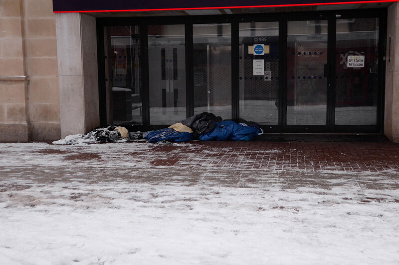 People sleeping outside, with snow on the ground People sleeping outside, with snow on the ground